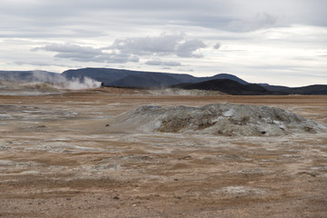 Geothermal area of Hverir in Iceland with people and steam.