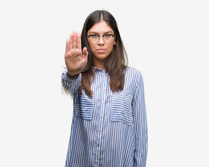 Young beautiful hispanic business woman doing stop sing with palm of the hand. Warning expression...