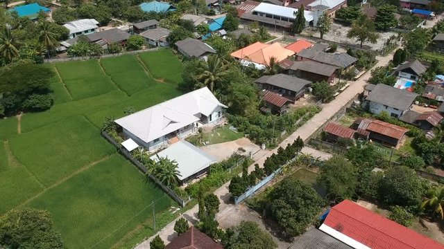 Full HD footage aerial view moving backward countryside in Thailand and rice field. Drone shot.