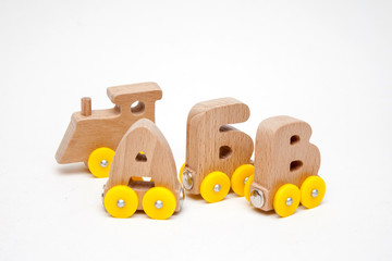 Russian wooden letters train alphabet with yellow wheels on a white background. Early childhood education, learning to read, preschool and kids game concept.
