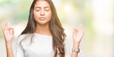 Young beautiful arab woman over isolated background relax and smiling with eyes closed doing meditation gesture with fingers. Yoga concept.