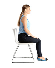 Woman sitting on chair against white background. Posture concept