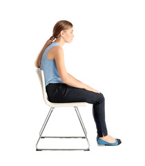 Woman sitting on chair against white background. Posture concept