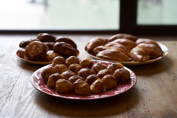 Homemade buns stuffed with cottage cheese, vegetables and chicken on a wooden table background.