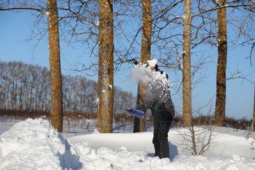 man remove snow with shovel from the road in winter 