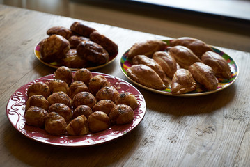 Homemade buns stuffed with cottage cheese, vegetables and chicken on a wooden table background.