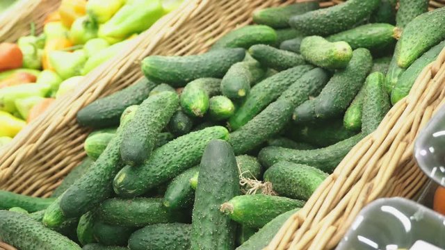 A woman in a supermarket buying vegetables