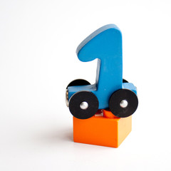 wooden numbers 0,1,2,4 letters train cars alphabet . Bright colors of red yellow green on a white background. Early childhood education, learning to count, preschool and kids game concept