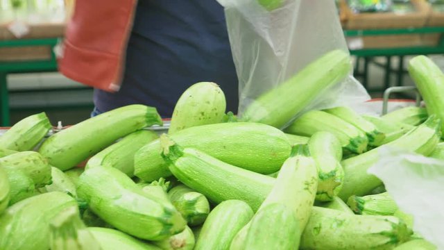 A woman in a supermarket buying vegetables