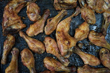 Grilled chicken drumsticks background, top view, close-up. Roasted chicken legs, Cooked with sauce