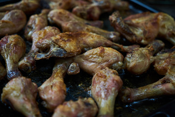 Grilled chicken drumsticks background, close-up. Roasted chicken legs, Cooked with sauce