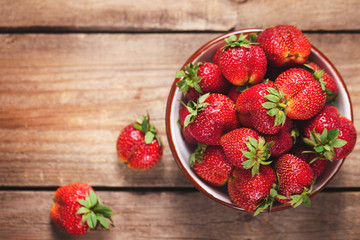 strawberries on a plate on wooden table