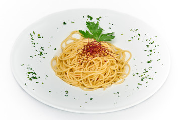 Italian food,spaghetti with garlic, oil and hot peppers, served on white plate, isolated on white background