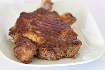 Beautifully seared tomahawk steak on the plate, medium rare to rare.Barbecue Kobe Tomahawk Steak
