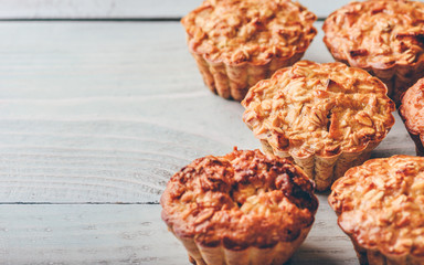 Cooked muffins on wooden background.