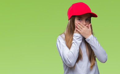 Young beautiful girl wearing red cap isolated background shocked covering mouth with hands for mistake. Secret concept.