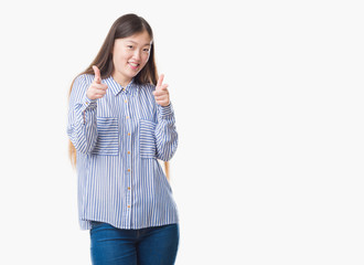 Fototapeta premium Young Chinese woman over isolated background pointing fingers to camera with happy and funny face. Good energy and vibes.
