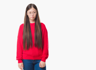 Young Chinese woman over isolated background wearing glasses depressed and worry for distress, crying angry and afraid. Sad expression.