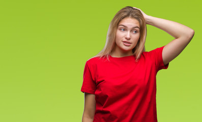 Young caucasian woman over isolated background confuse and wonder about question. Uncertain with doubt, thinking with hand on head. Pensive concept.