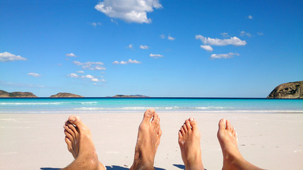 Summer and beach concept - couple lying on beach