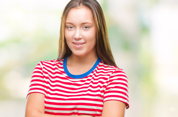 Young caucasian beautiful woman over isolated background happy face smiling with crossed arms looking at the camera. Positive person.