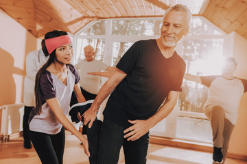 Fototapeta premium Smiling Patient. Young Instructor. Men. Exercises.