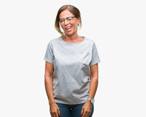 Middle age senior hispanic woman wearing glasses over isolated background winking looking at the camera with sexy expression, cheerful and happy face.