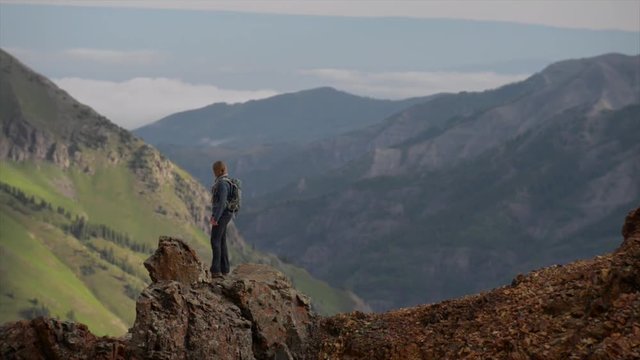 Girl Hiker walks along steep mountain ridge San Juan Mountains Colorado