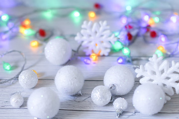 new year or Christmas decorations in silver and white colors with balls, snowflakes and garland bokeh