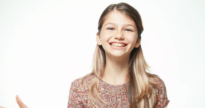 Teenager girl laughing at camera on the white background. Close up portrait