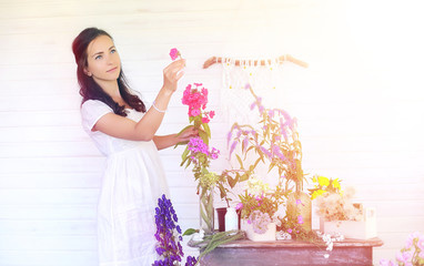 A young girl with a daughter is picking up a bouquet. A young mo