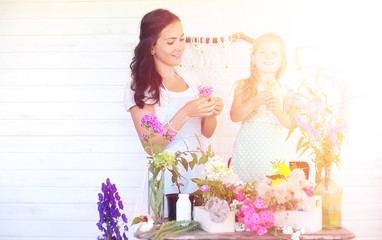 A young girl with a daughter is picking up a bouquet. A young mo