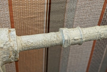 part of the white iron pipe and battery in the room