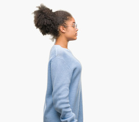 Young afro american woman wearing glasses over isolated background looking stressed and nervous with hands on mouth biting nails. Anxiety problem.