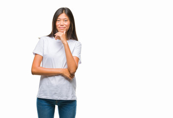 Young asian woman over isolated background looking confident at the camera with smile with crossed arms and hand raised on chin. Thinking positive.