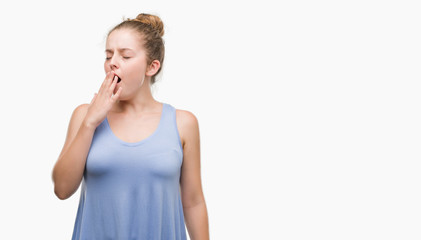 Fototapeta premium Young blonde woman bored yawning tired covering mouth with hand. Restless and sleepiness.