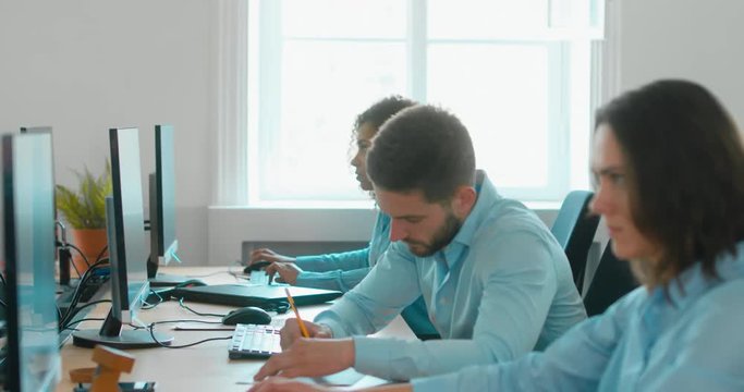 Stressful mid 30s Caucasian male working in the office, trying to find the solution. 4K UHD 60 FPS SLOW MOTION