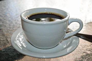 Coffee served in white cup and saucer 