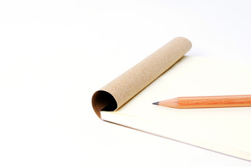 Close up of Pencil put on notepad paper on white background