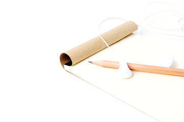 Close up of pencil with ear phone on notepad paper for learn concept