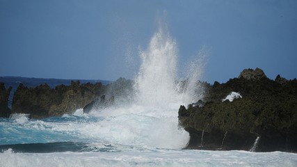 Fototapeta na wymiar Huge waves slapping against sharp cliff lines create an amazing view