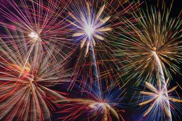 Colorful fireworks of various colors over sky at night - use for background and texture.