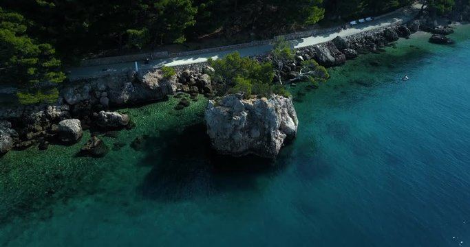 Drone shot of rocky coastline along with sea, Brela, Croatia