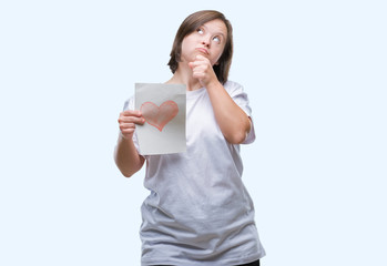 Young adult woman with down syndrome holding red heart card over isolated background serious face thinking about question, very confused idea