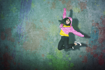 Female hip-hop dancer jumping and dancing