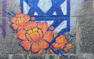 Fragment of graffiti drawings. The old wall decorated with paint stains in the style of street art...