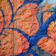 Fragment of graffiti drawings. The old wall decorated with paint stains in the style of street art...