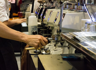 Barista working in a coffee shop, Close up of barista presses ground coffee using tamper, Barista Make Coffee Portafilter Concept