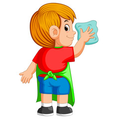 the deligent boy doing a daily activity to clean up with the blue towel 
