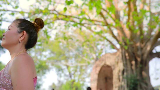 asian woman wearing thai tradition clothes with lotus bouquet in hand